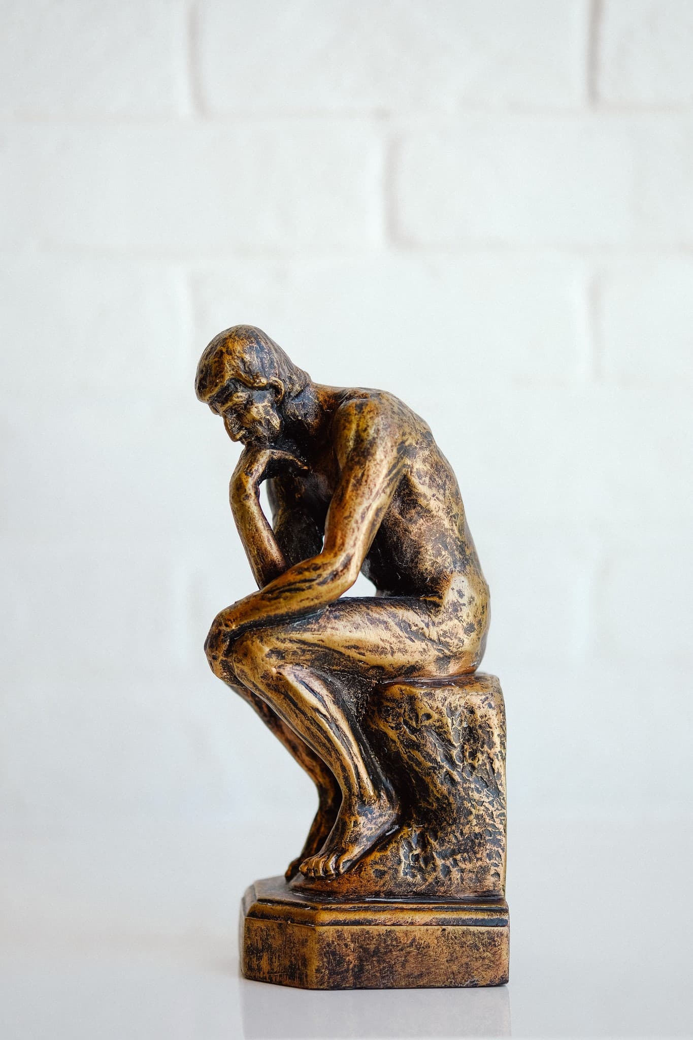 Bronze figure seated in thought
