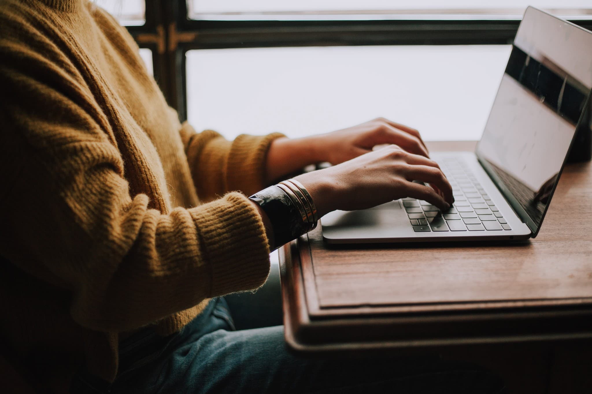 Person preparing legal service information on a laptop